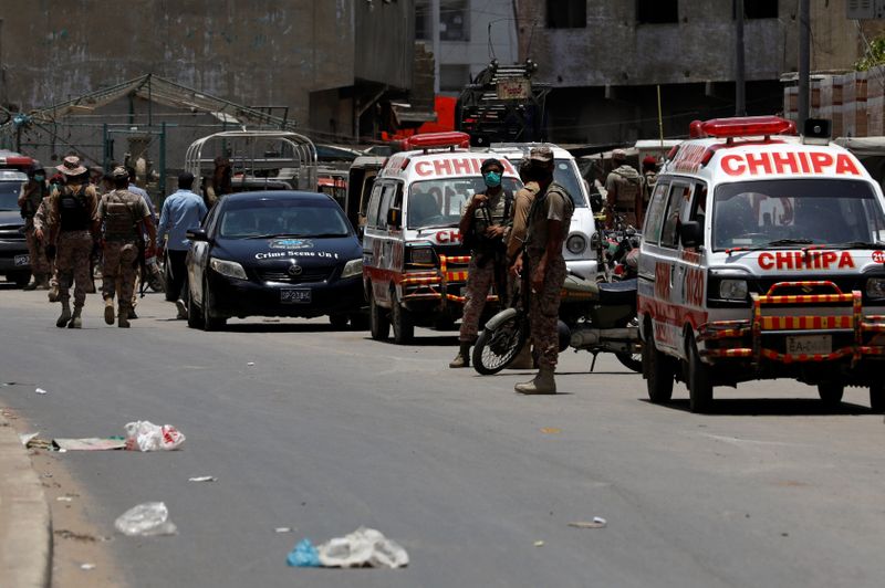 Paramilitary soldiers and ambulances are seen, after a grenade blast