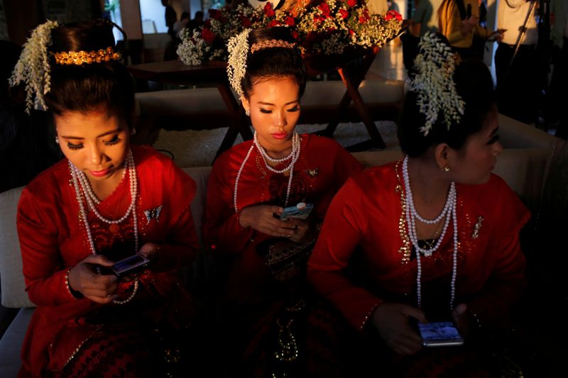 FILE PHOTO: Traditional dancers wait to perform at the Rakhine