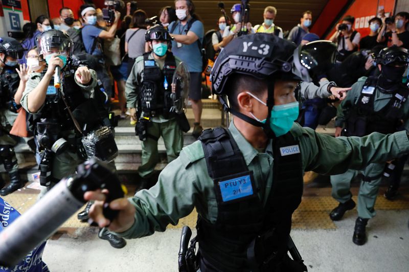 FILE PHOTO:  Riot police disperse pro-democracy demonstrators as they