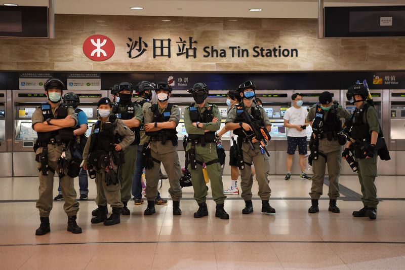 Police stand at a metro station near a pro-democracy protest