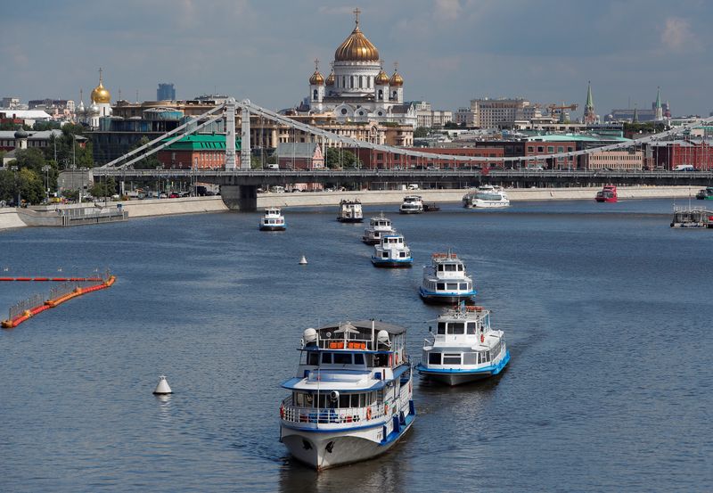 Cruise vessels sail along the Moskva River in Moscow