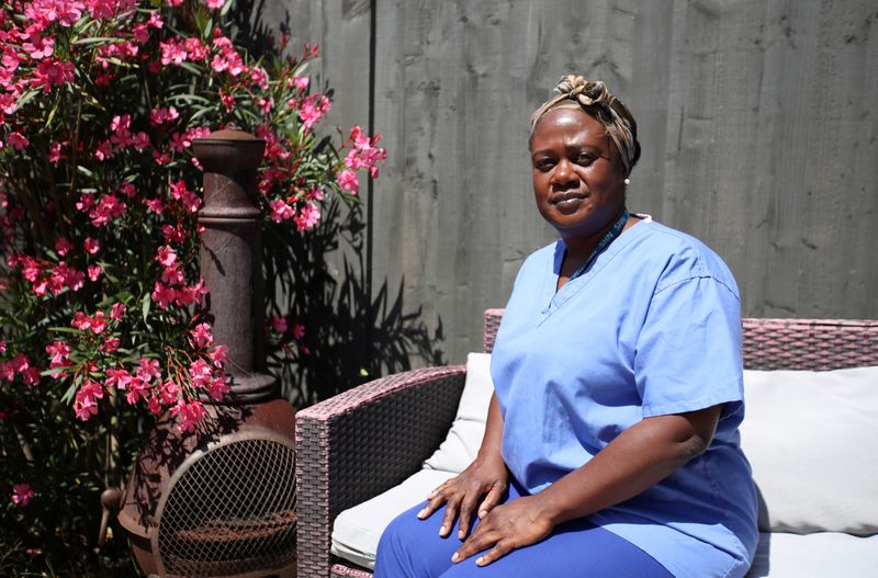 Nurse Neomi Bennett poses for a photo at her home