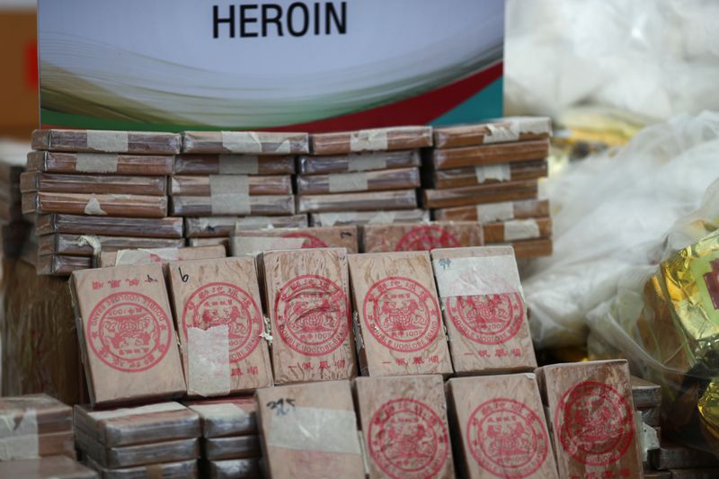 Bricks of heroin wrapped in plastic are pictured during the
