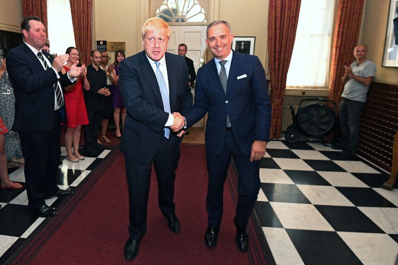 Britain’s Prime Minister Boris Johnson shakes hands with Mark Sedwill