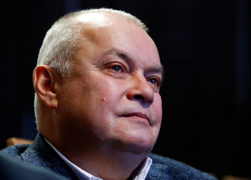 Russian state TV anchorman Kiselyov listens to one-time advisor of