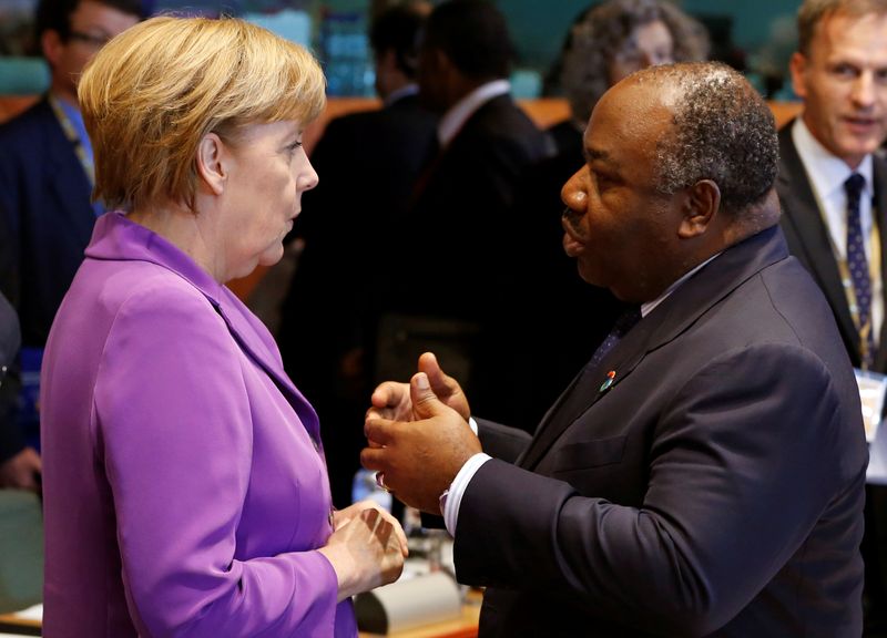 FILE PHOTO: Germany’s Chancellor Merkel talks with Gabon’s President Ondimba