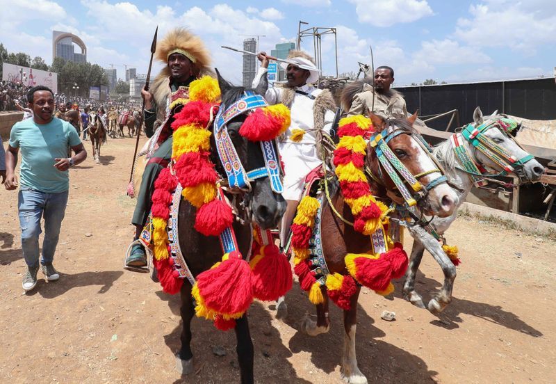 Ethiopian Oromo musician, Haacaaluu Hundeessaa, rides a horse in traditional