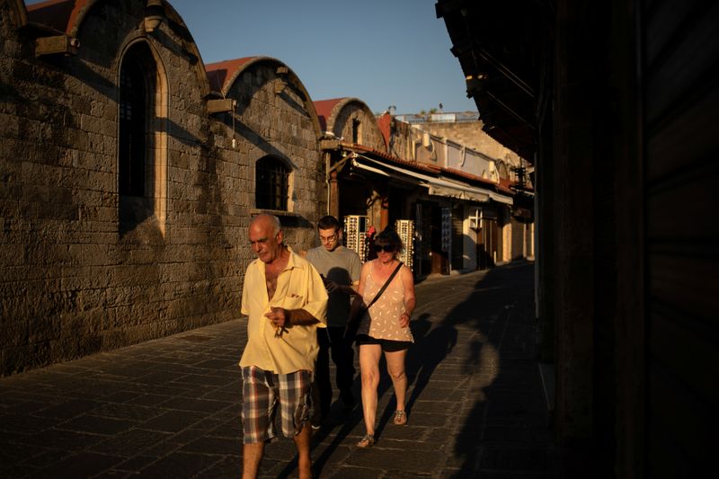 People make their way in the Old Town of Rhodes,