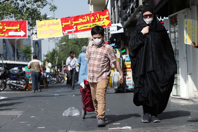 FILE PHOTO: An Iranian woman and her son wearing a