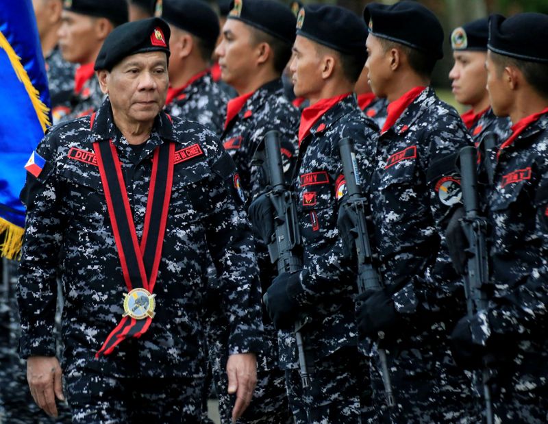 FILE PHOTO: Philippine President Rodrigo Duterte, wearing a military uniform,