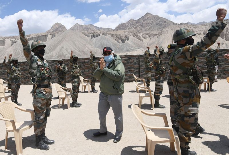 India’s PM Modi gestures as he interacts with army soldiers