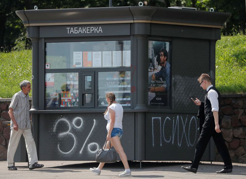 People walk past a kiosk in Minsk
