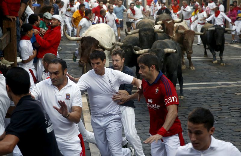 FILE PHOTO: Runners lead Miura fighting bulls during the last
