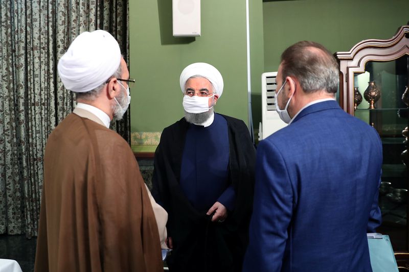Iranian President Hassan Rouhani is seen wearing a face mask