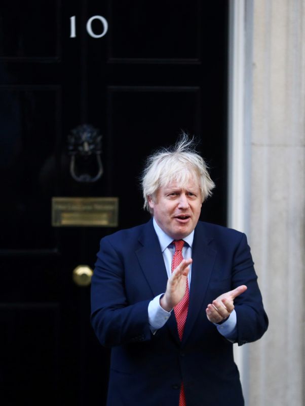FILE PHOTO: British Prime Minister Boris Johnson applauds the NHS