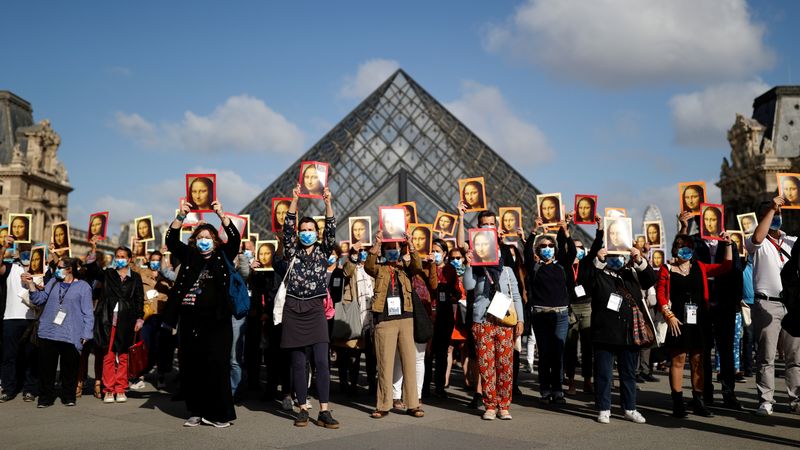 Paris tour guides gather at Le Louvre museum in Paris
