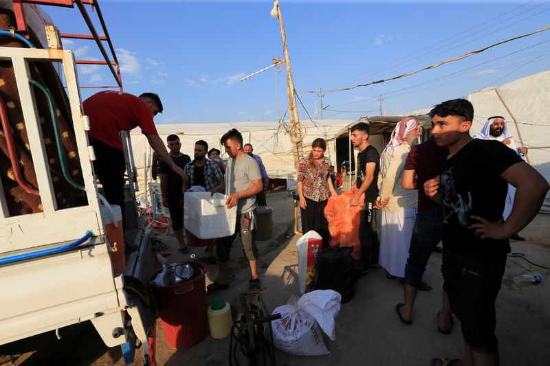 Yazidi displaced family al-Hamo leave their home in Sharya town
