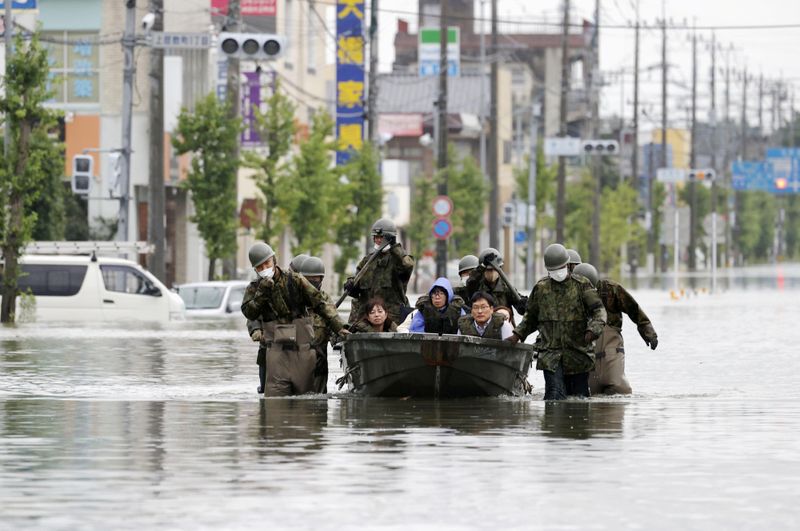 Local residents are rescued by Japan Self-Defense Force soldiers using
