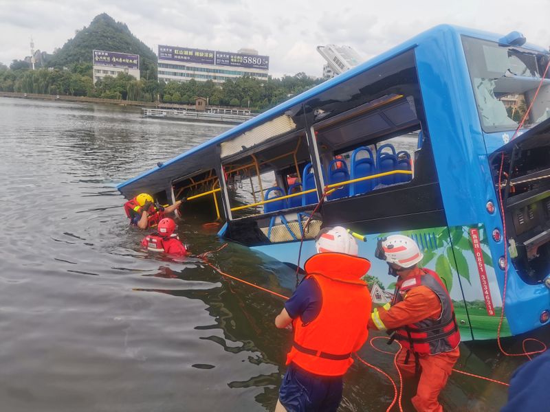 Rescue workers are seen at the site where a bus