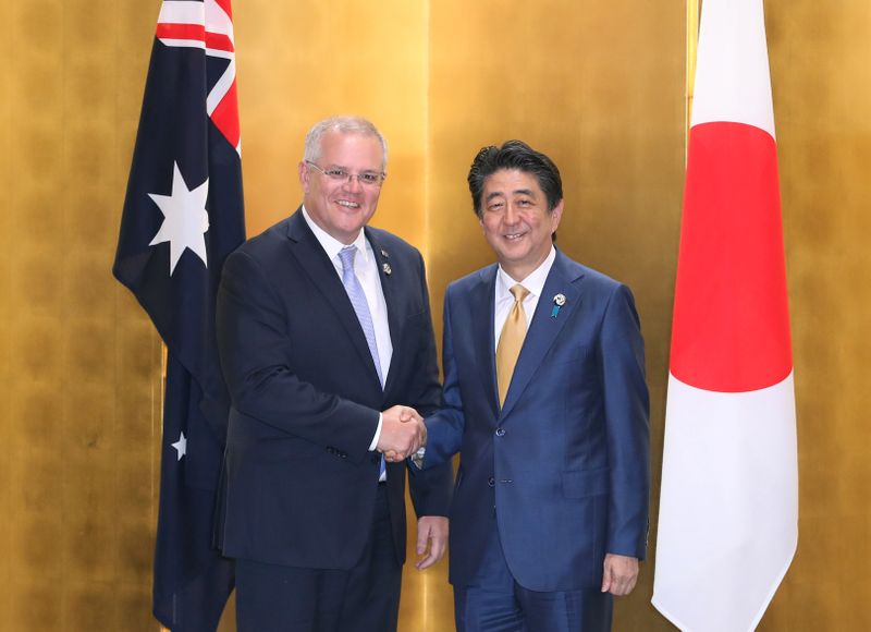 The Prime Minister of Australia Scott Morrison shakes hands with