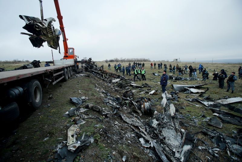 FILE PHOTO: A crane carries wreckage of the Malaysia Airlines