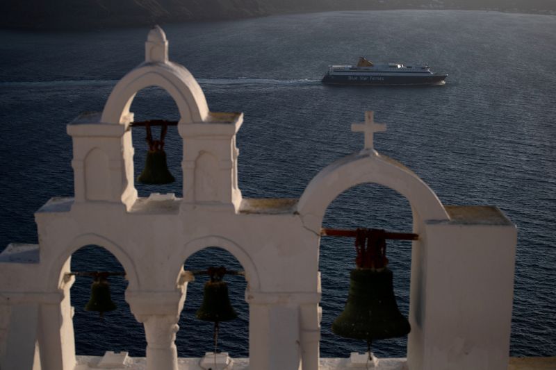 FILE PHOTO: A ferry sails near the island of Santorini,