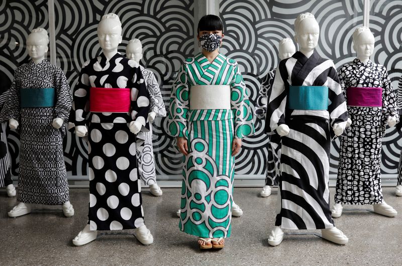 Japanese artist Hiroko Takahashi wears a protective face mask as