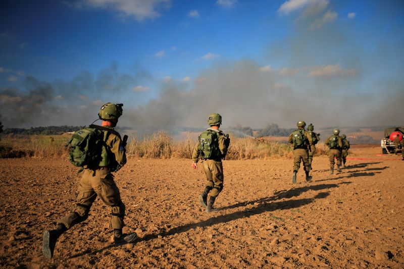 Israeli soldiers try to extinguish fire, on the Israeli side