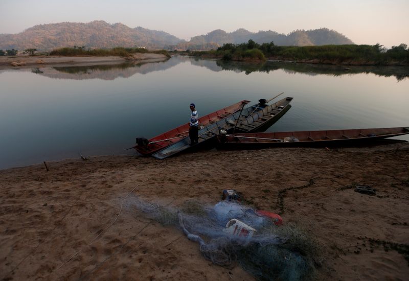 FILE PHOTO: A fisherman is seen on the  Mekong