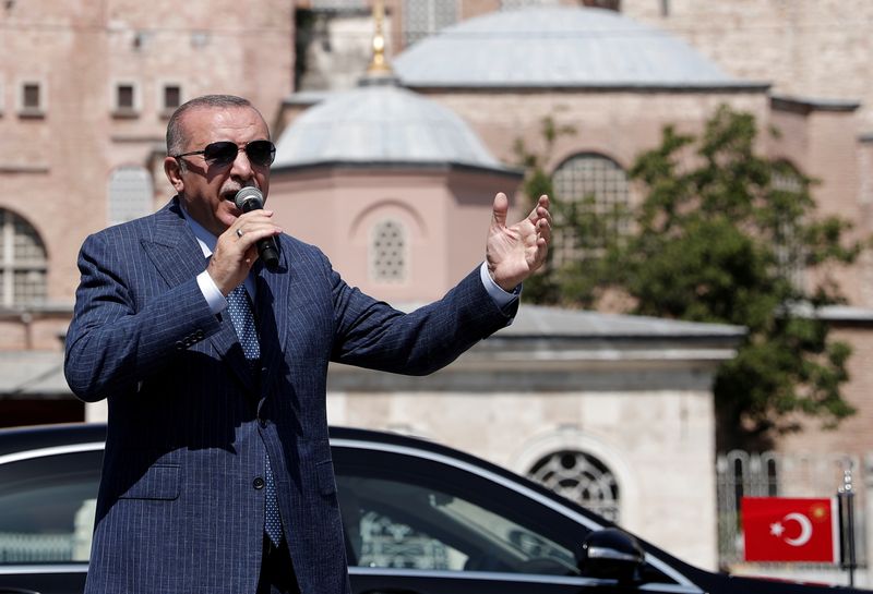 FILE PHOTO: Turkish President Erdogan talks to the media after