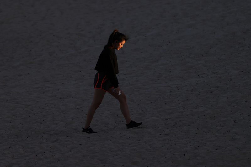 A woman walks at Coogee Beach in Sydney