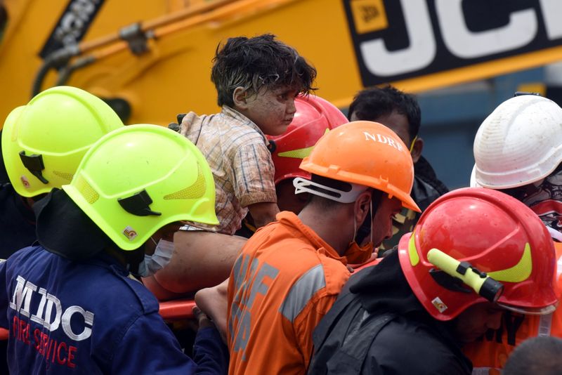Rescue workers carry Mohammed Bangi after he was rescued from