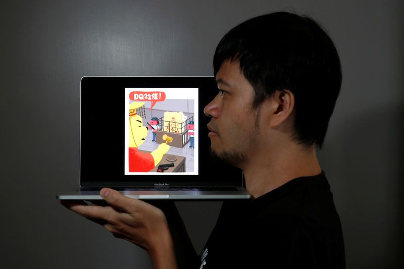 Political illustrator Ah To poses with his cartoon after his