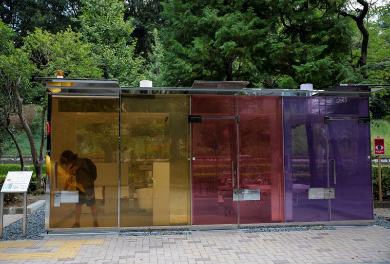 A visitor tries out the transparent public toilet that become