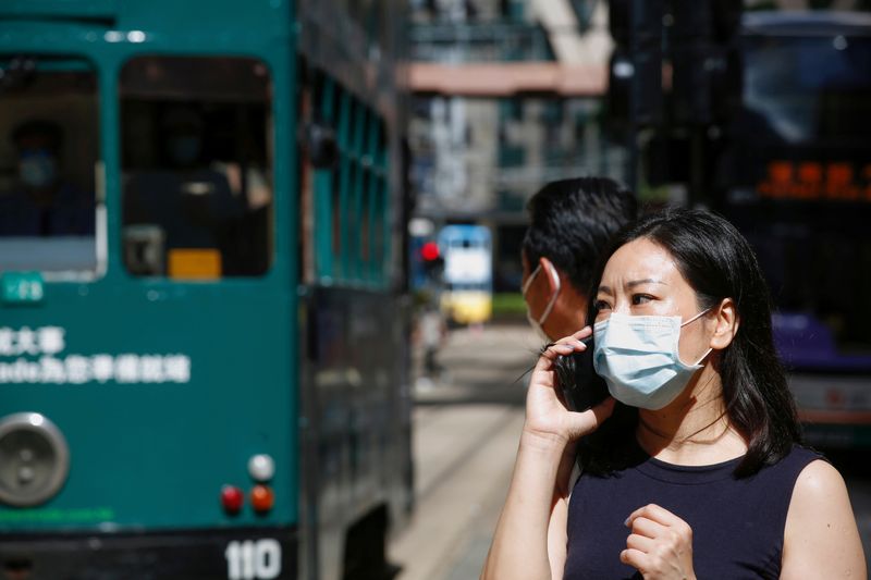 FILE PHOTO: A woman wears a surgical mask following the