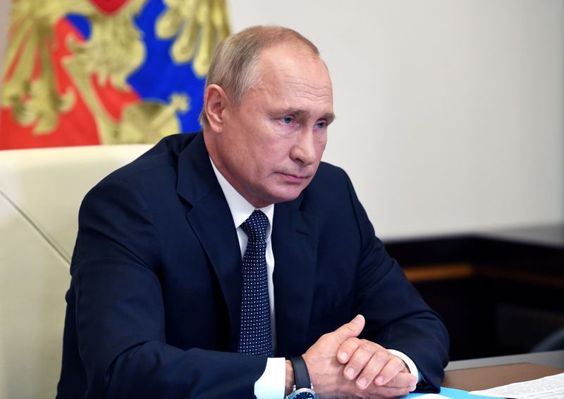 Russian President Putin chairs a meeting via video link outside