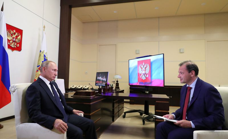 Russian President Vladimir Putin attends an interview with Russia’s Rossiya 24