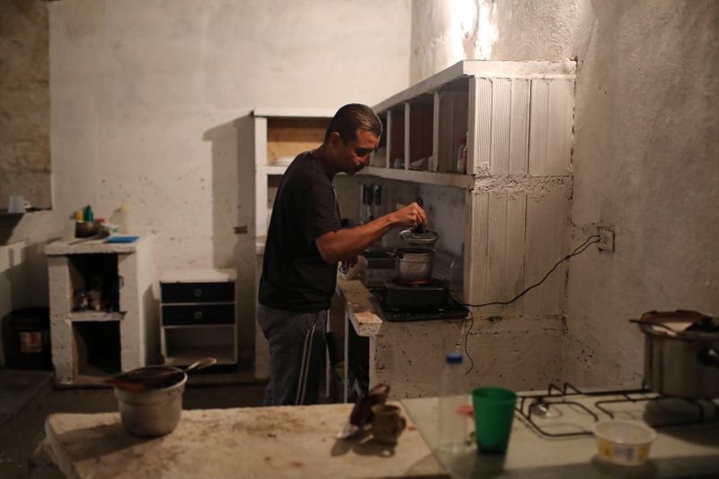 Juan Meza prepares coffee at his house in Guigue