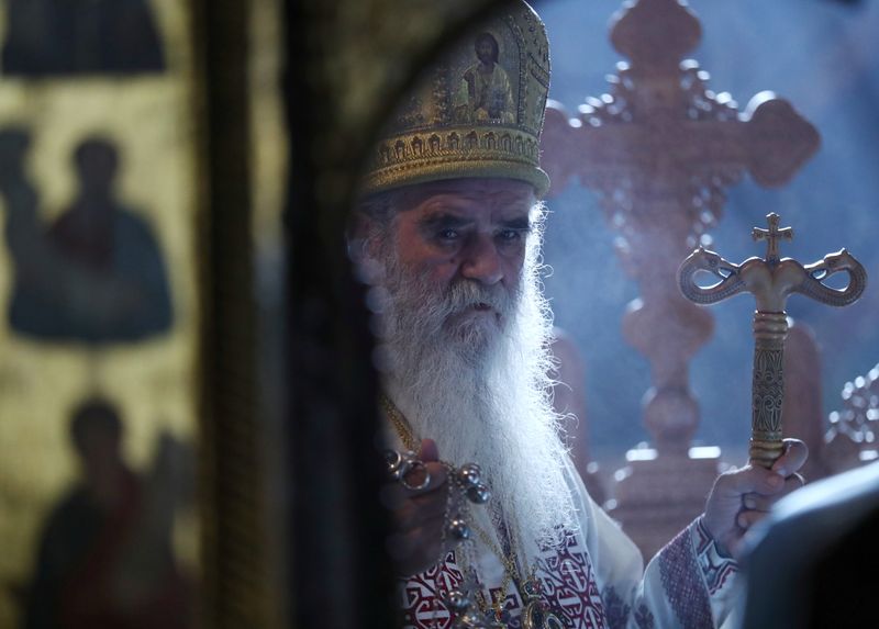 Metropolitan Amfilohije, the church’s top cleric in Montenegro prays in