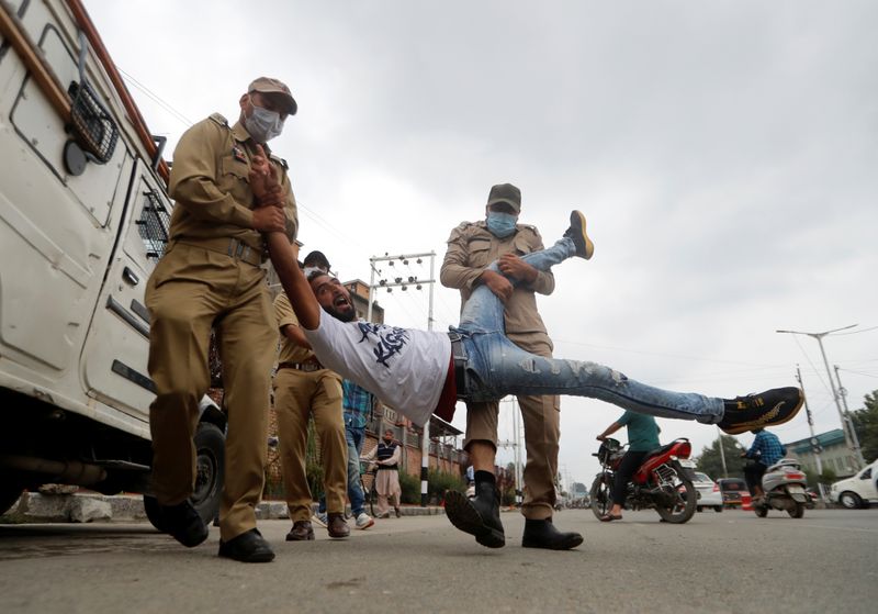 A Kashmiri Shi’ite Mulsim reacts as he is detained an