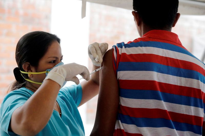 FILE PHOTO: A Venezuelan migrant receives a vaccination at the