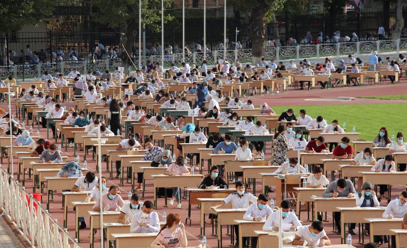 School graduates take university entrance exams at a sports arena