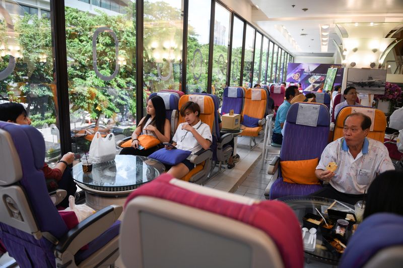 Customers eat at Thai Airways pop-up airplane-themed restaurant at the