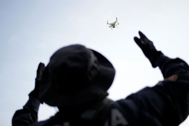 A police officer uses a drone during a search for
