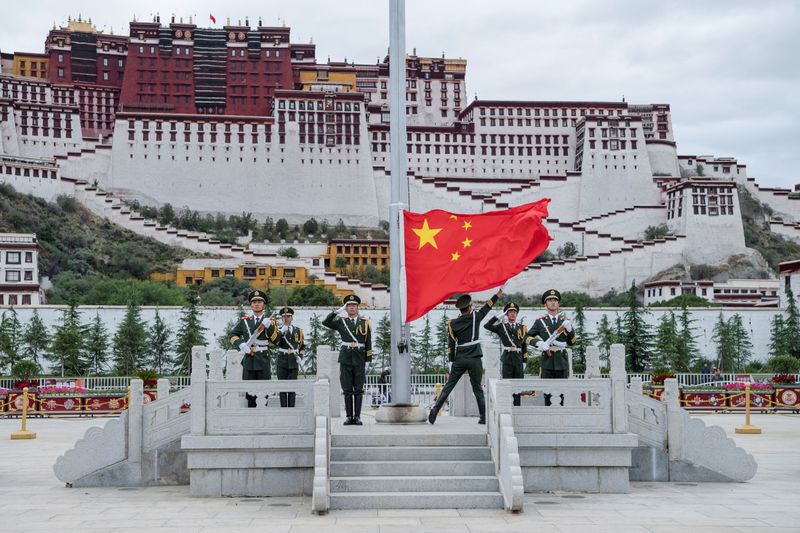 The Chinese national flag is raised at Potala Palace in