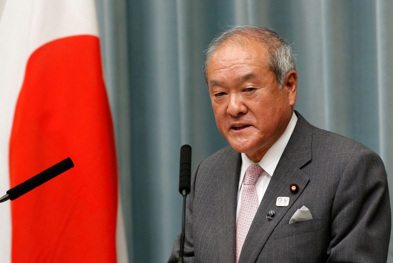 Japan’s Olympics Minister Shunichi Suzuki speaks at a news conference