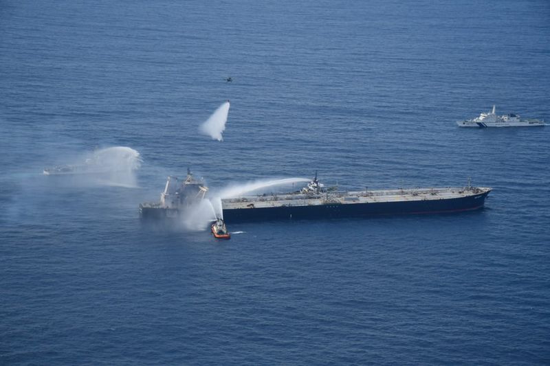 A Sri Lankan Navy boat sprays water on the New