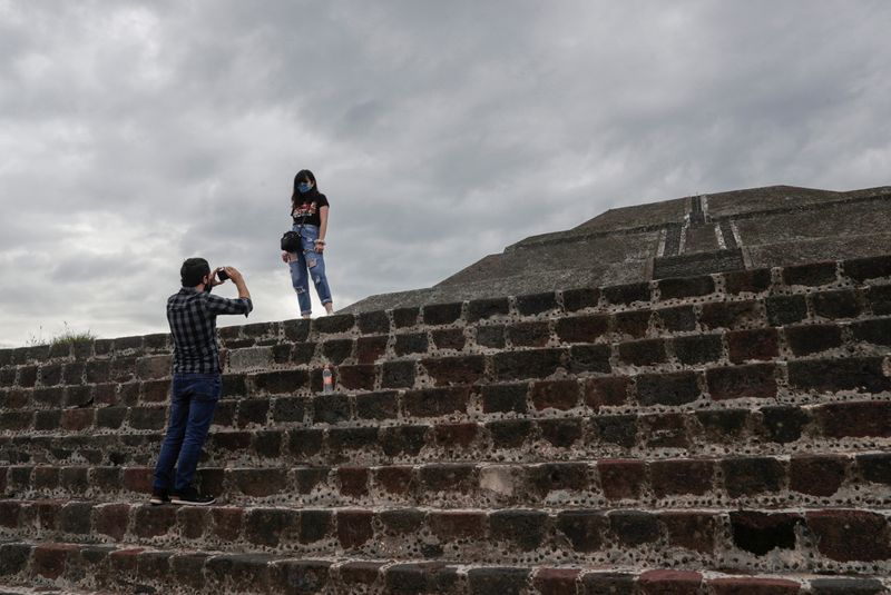 A couple takes pictures with a cellphone near Mexico City