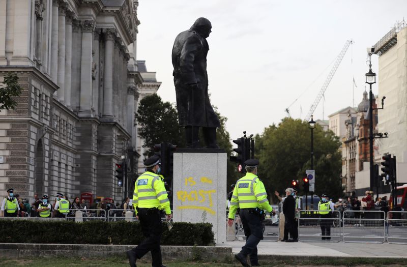 A graffiti is seen on the statue of Winston Churchill,