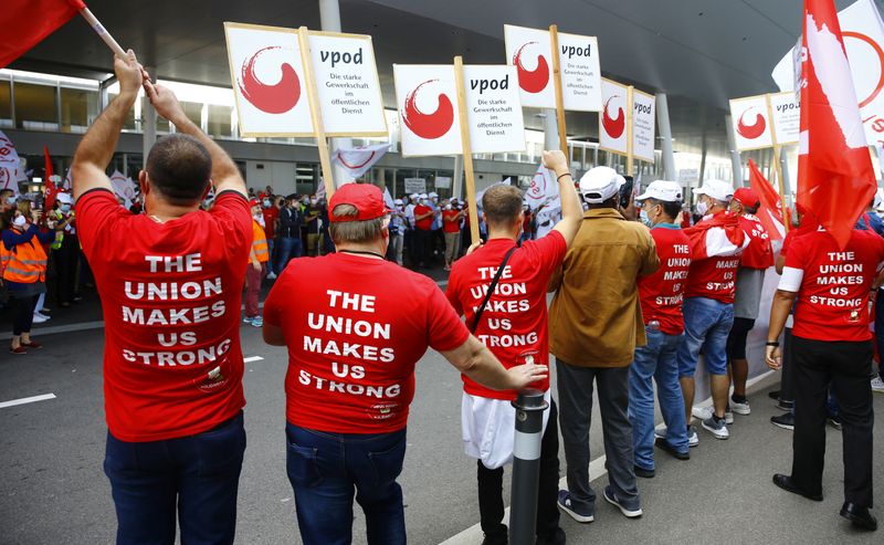 Members of the VPOD public services workers union display placards